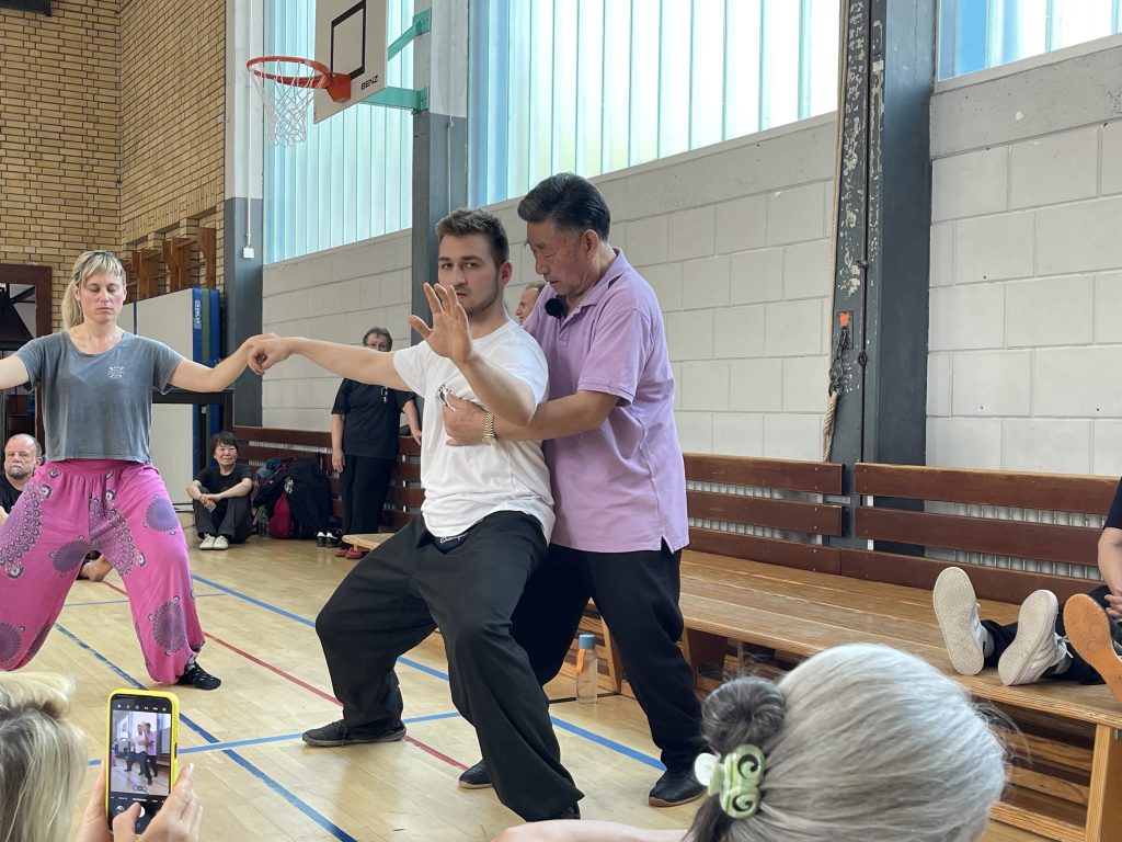 Tai Chi teacher correcting my stance