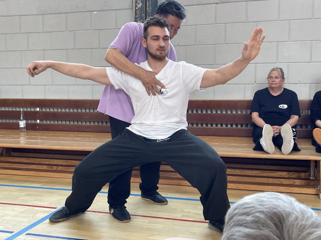 Tai Chi teacher correcting stance