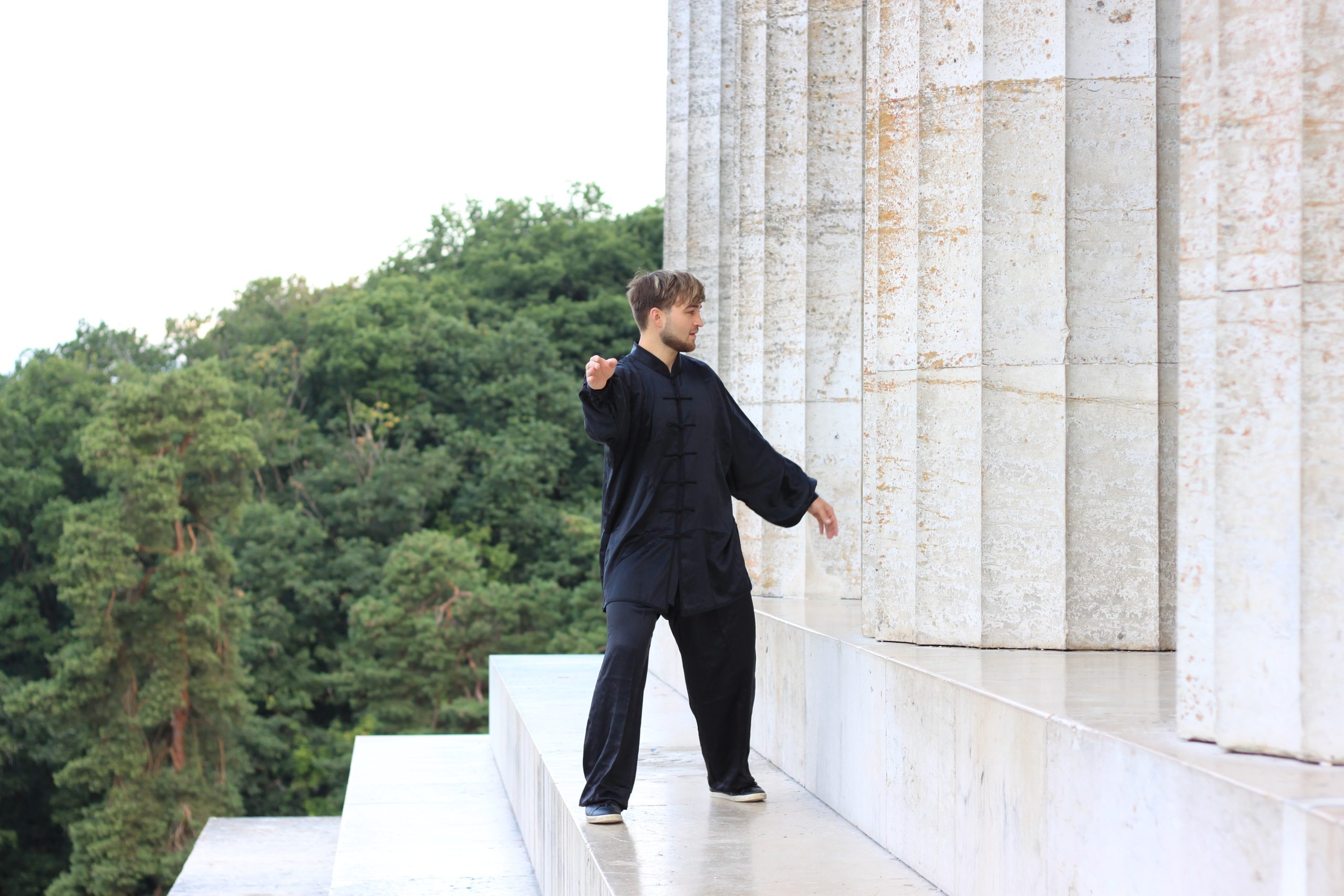 Tai Chi form in front of columns