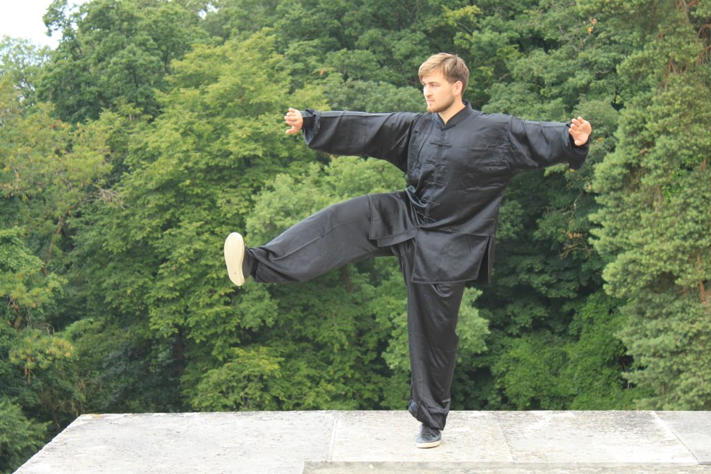 Chen Tai Chi one-leg kick on stone terrace
