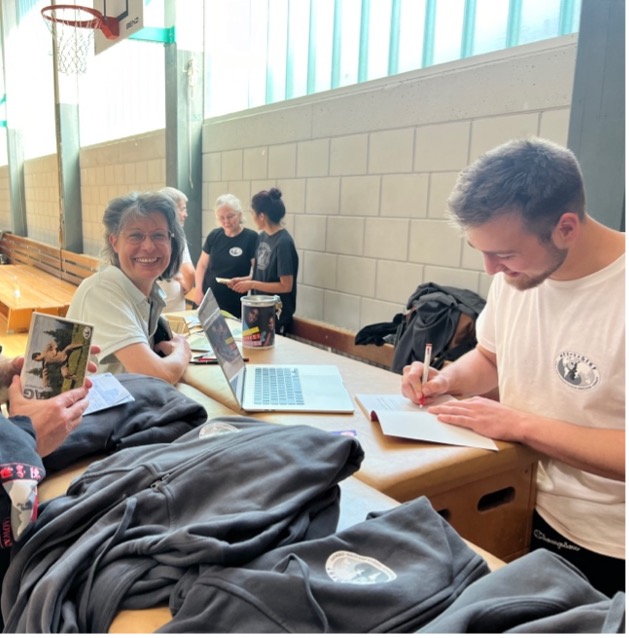 Tai Chi teacher signing books |