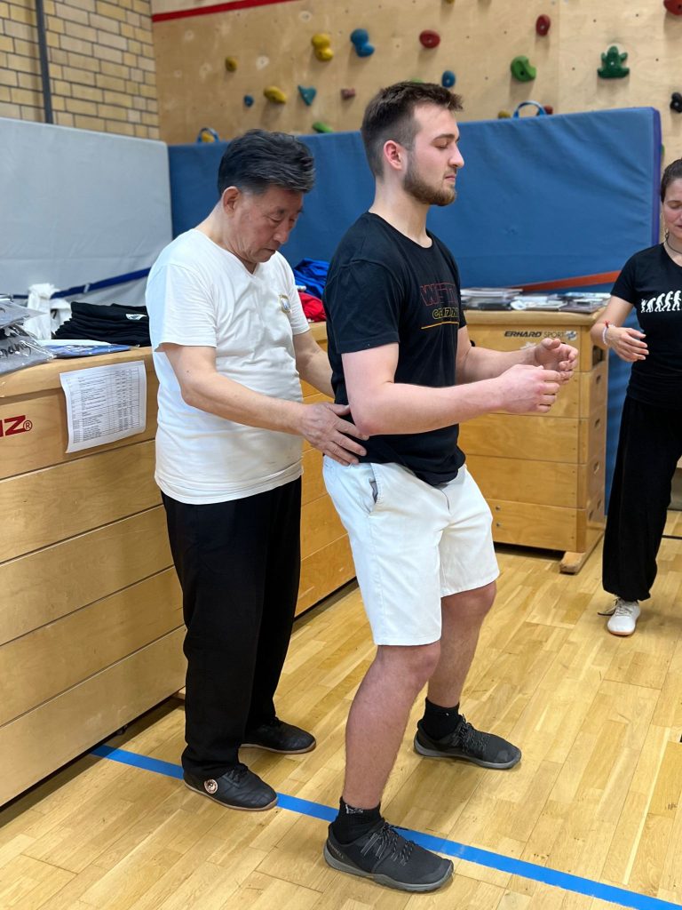 Practitioners studying Tai Chi manuals