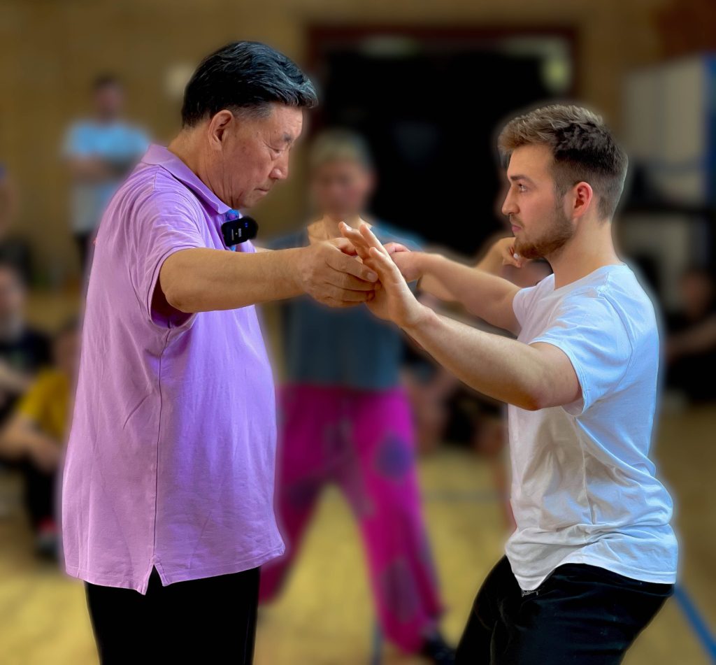 Students learning Tai Chi principles